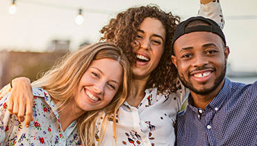 Three friends smiling