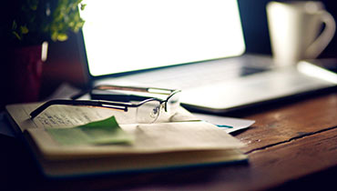 Glasses, book and laptop