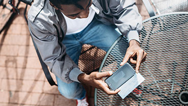 Man taking photo of check with phone