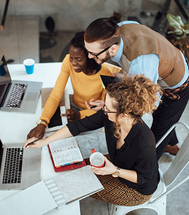 Coworkers in office on laptop