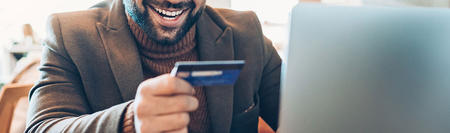 Man smiling with card