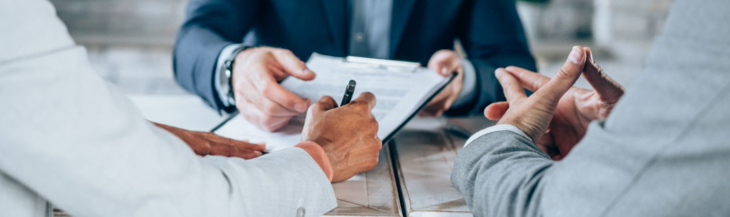 People Signing a paper 