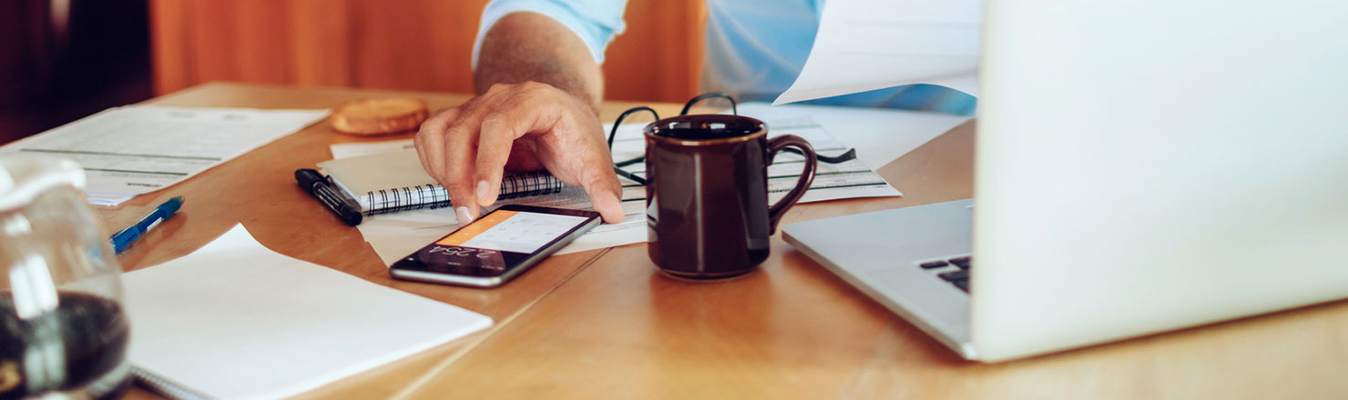 Man using calculator on phone