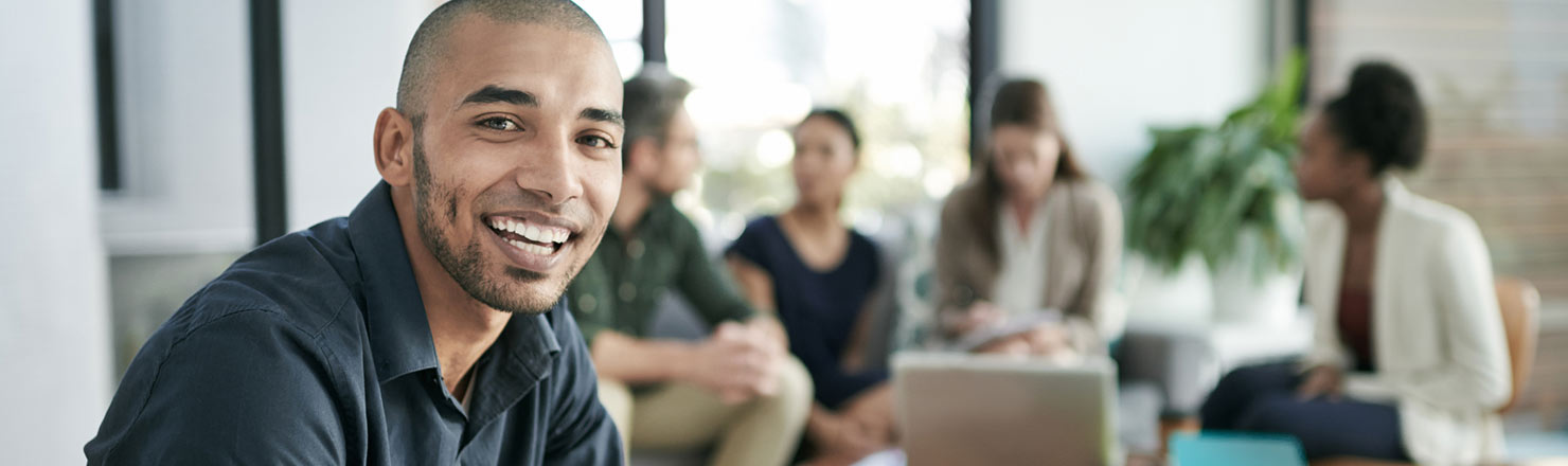 Man with coworkers in background